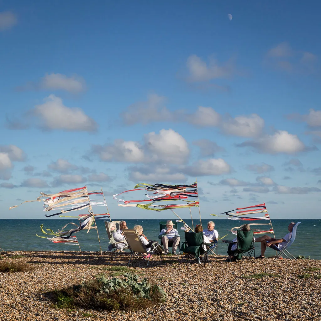 people with sitting in chairs on the beach