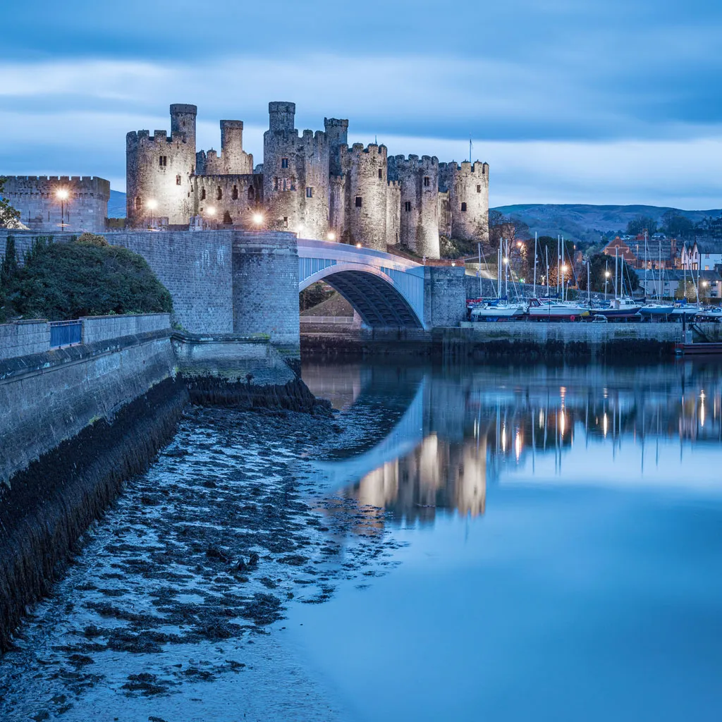 Convy castle at dusk reflected in the water