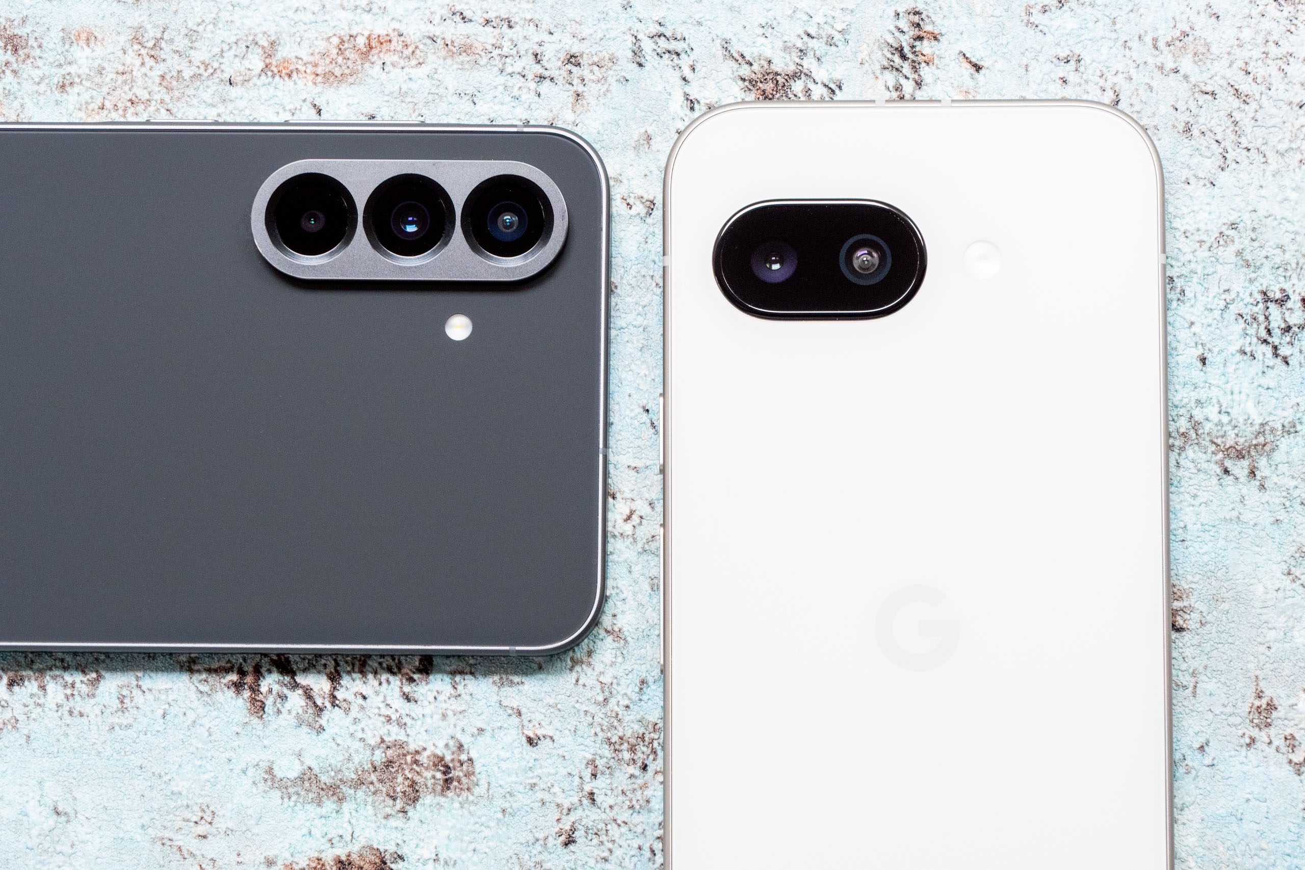 The camera units of the Samsung Galaxy A56 (left) and the Google Pixel 9a (right)