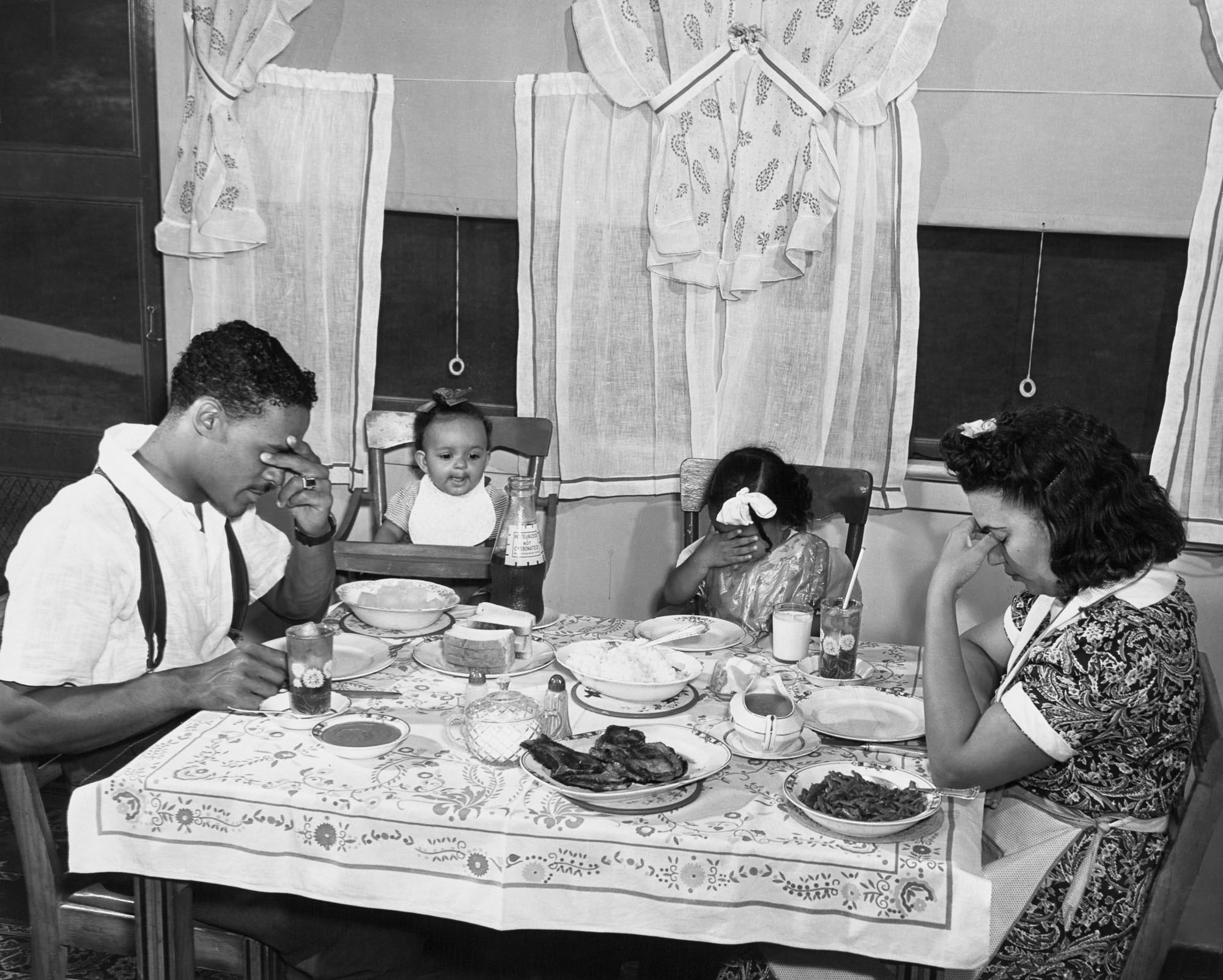 Gordon Parks Anacostia, D.C. Frederick Douglass Housing Project. A family says grace before the evening meal. June 1942 Courtesy of and copyright The Gordon Parks Foundation