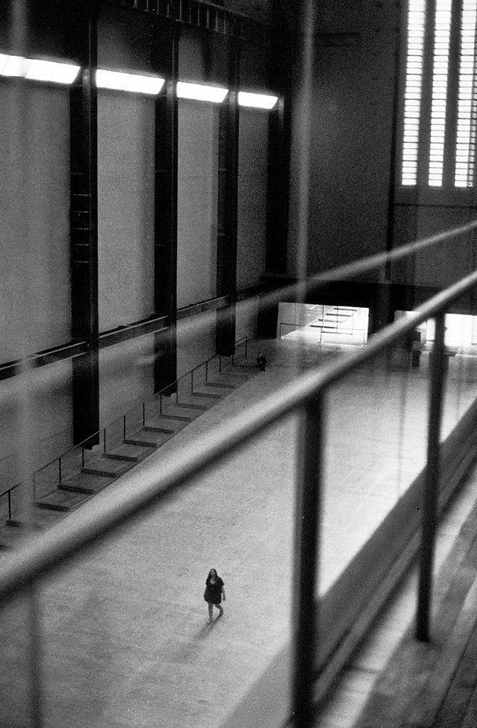 single person walking through tate modern turbine hall