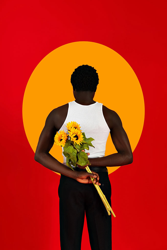 portrait of a person against yellow circle and red background